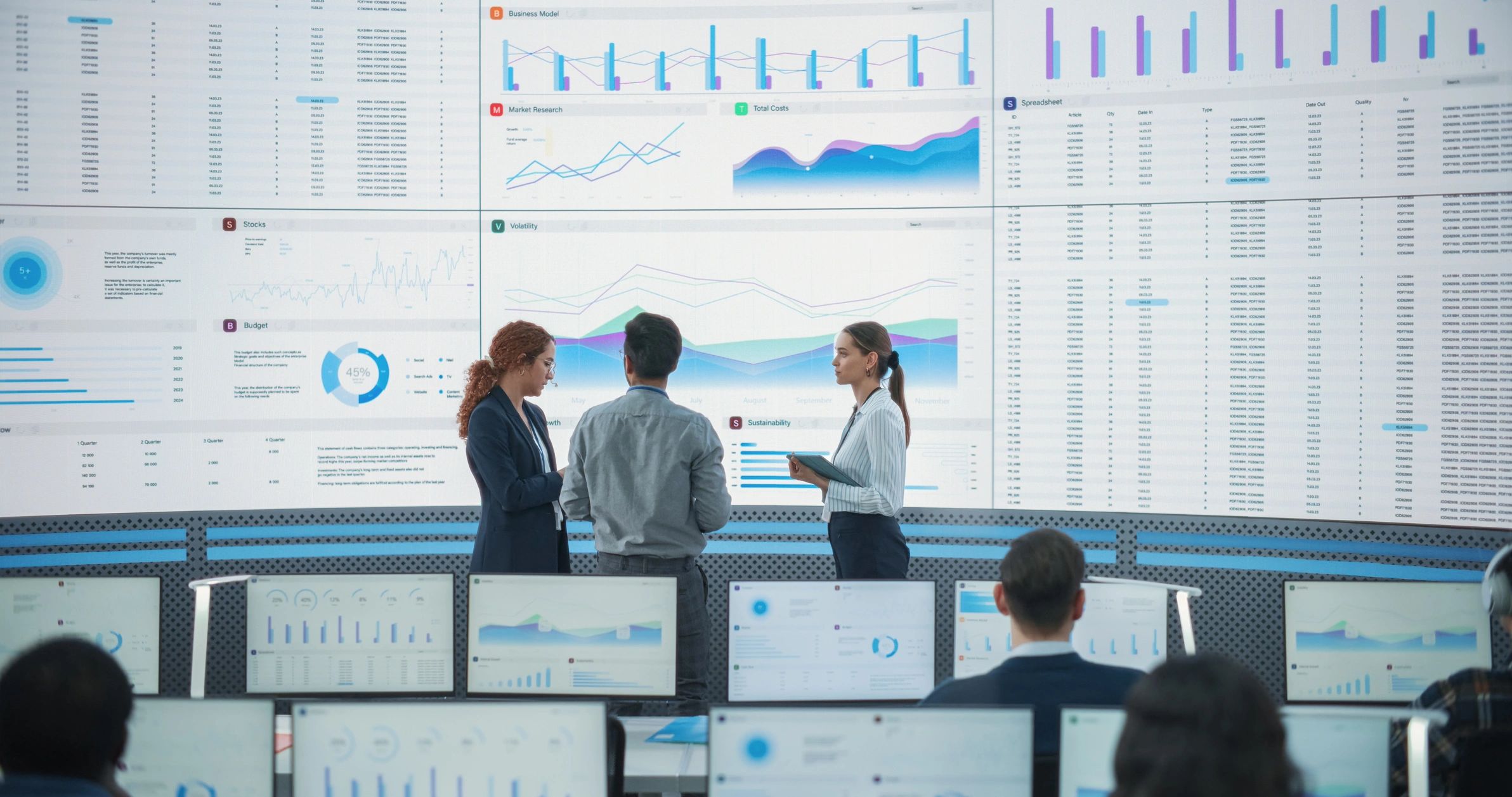 Technology operations team monitoring systems in a control room