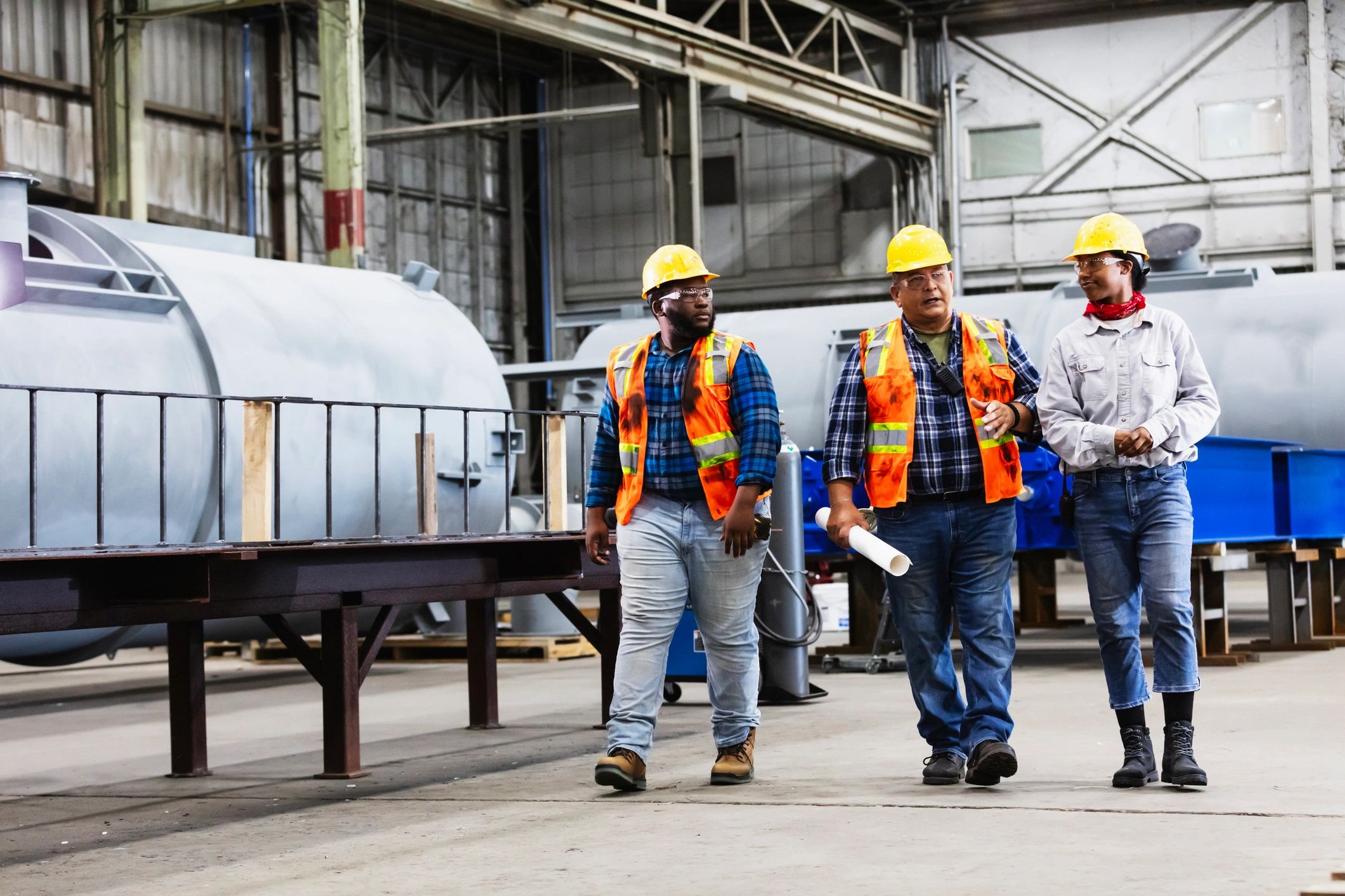 Engineers and workers discussing safety and plans at an industrial site